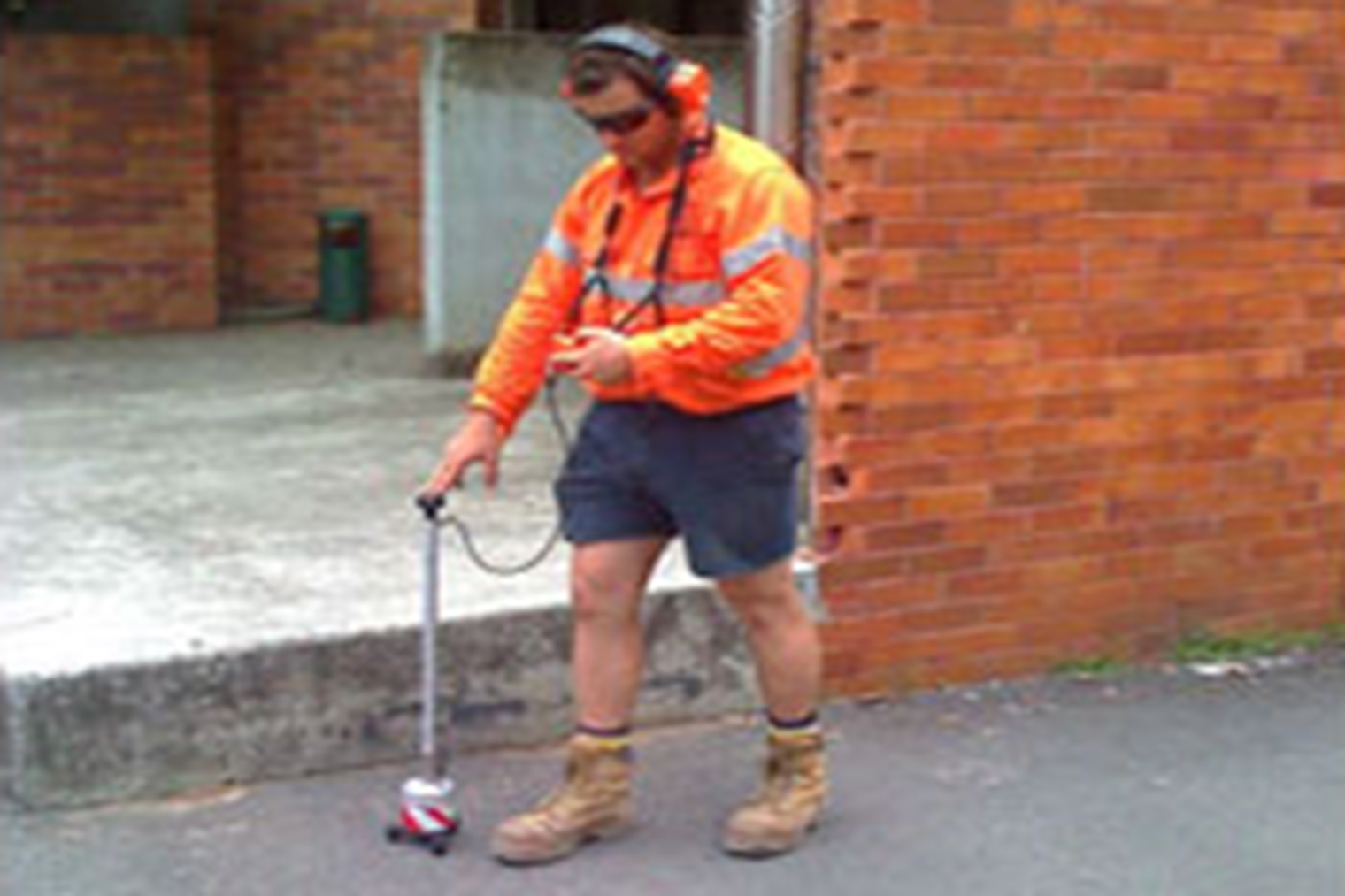 Worker conducting acoustic water leak detection | Featured image for the Acoustic Leak Detection service page for 1300Locate.
