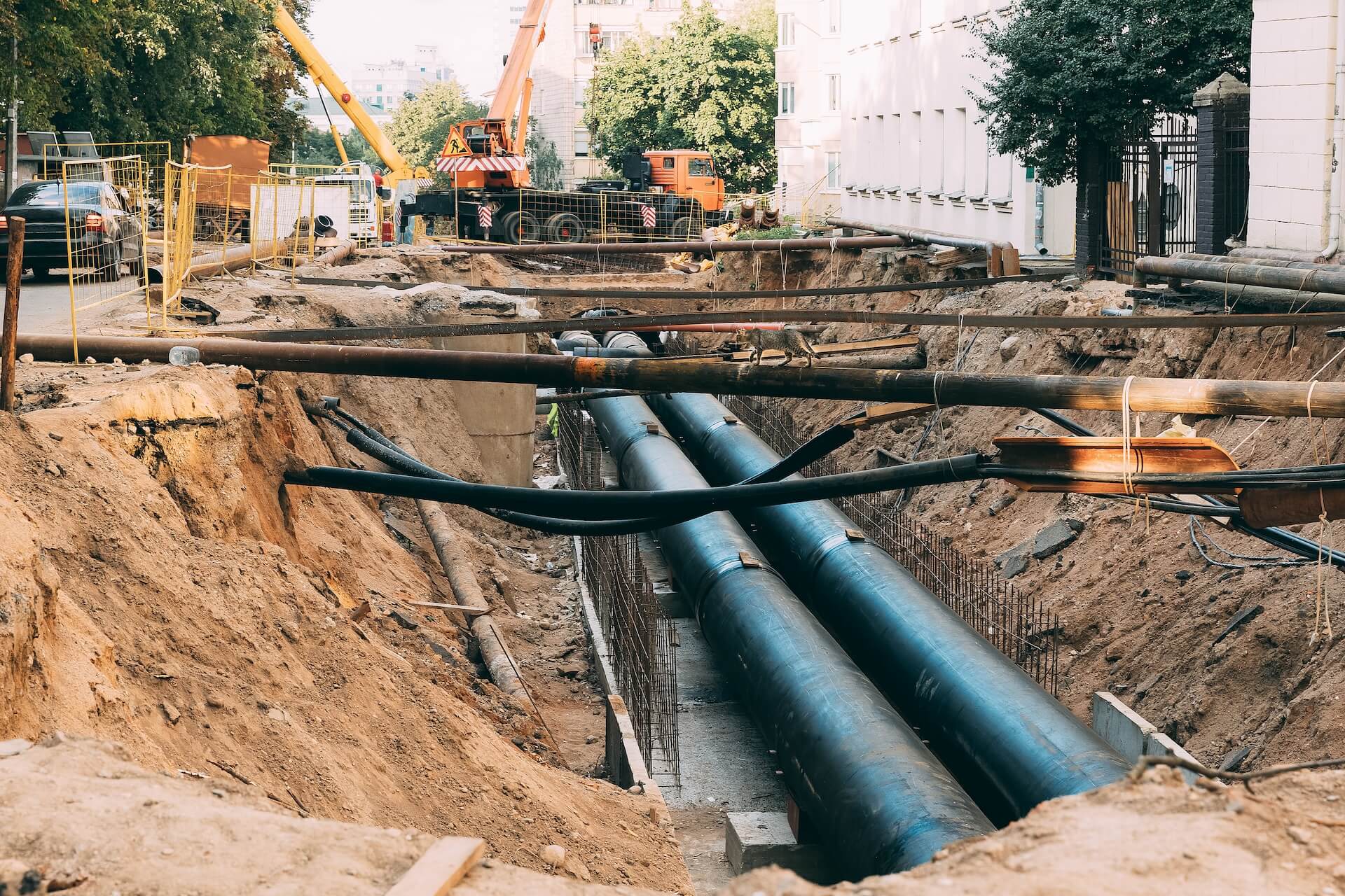 Assorted underground utilities at street level | Featured Image for The Cost of Ignoring Underground Utilities blog of 1300Locate.